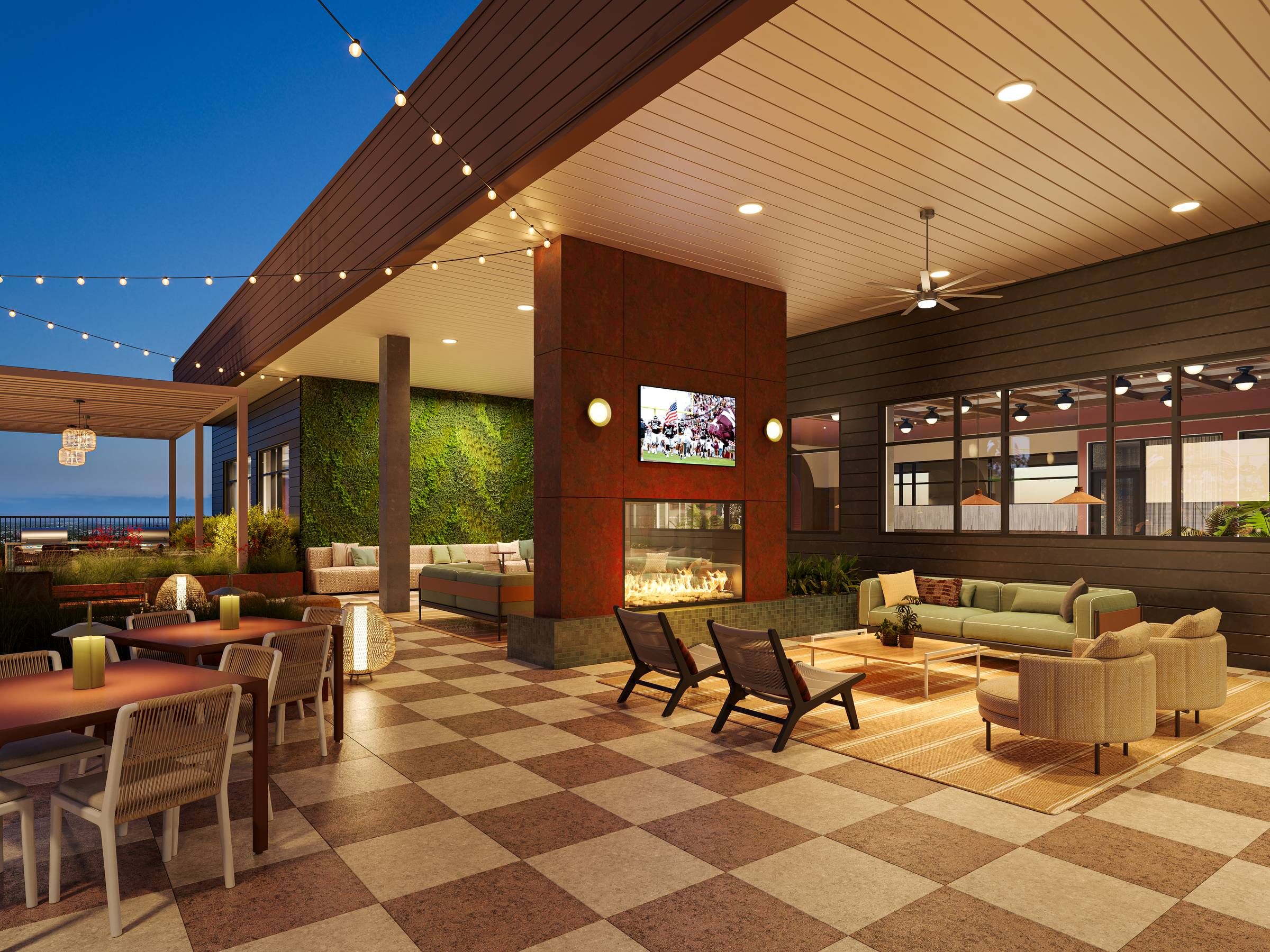 Ever College Station student living apartments Modern outdoor patio with string lights, lounge seating, fireplace, and a green wall at dusk.