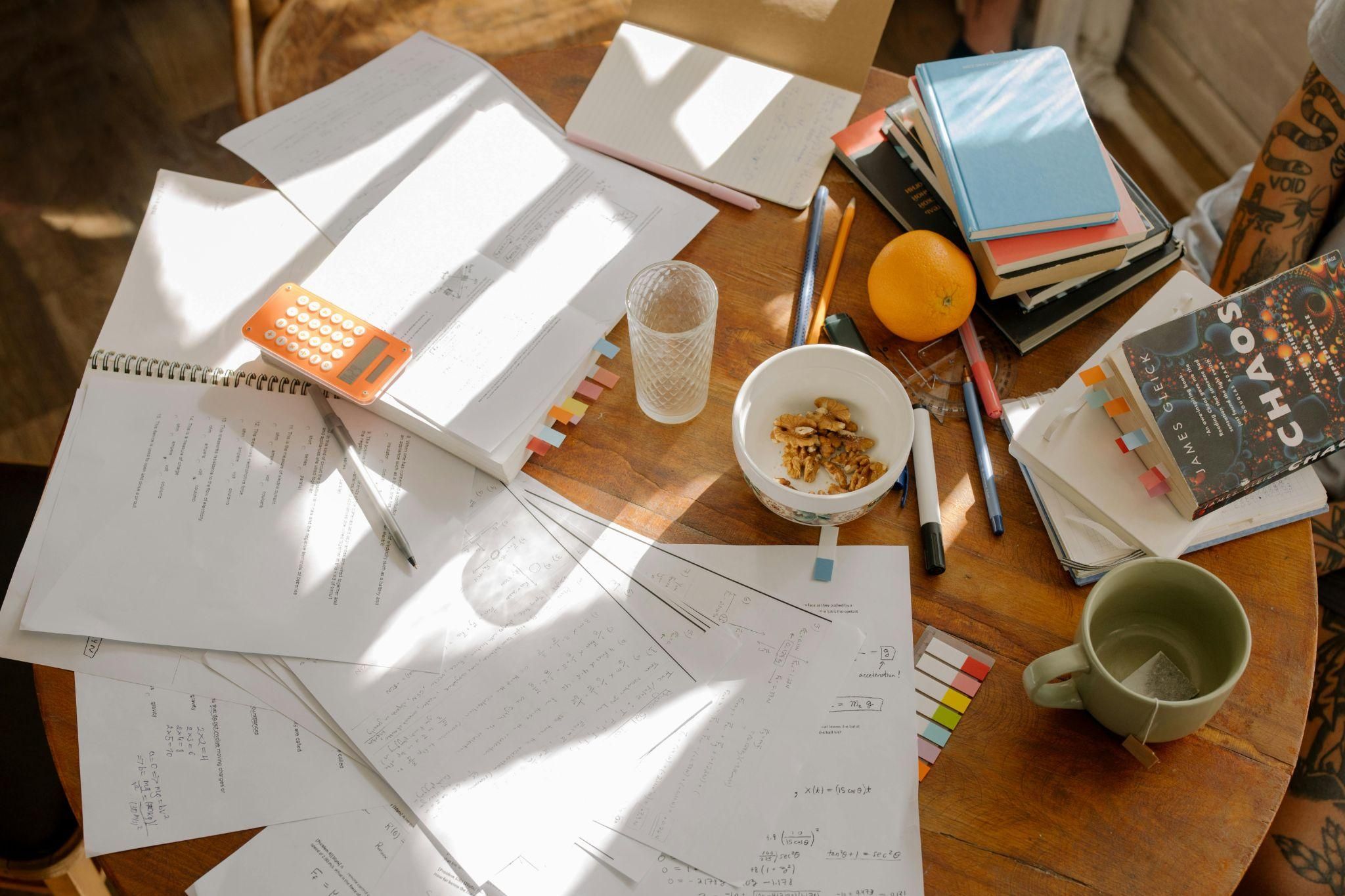 Student study desk with notebooks, calculator, and coffee showcasing focused study space at EVER College Station