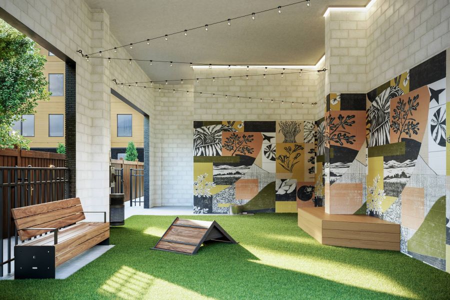 Ever College Station student living apartments Modern outdoor lounge with string lights, benches, and colorful mural walls on artificial grass.