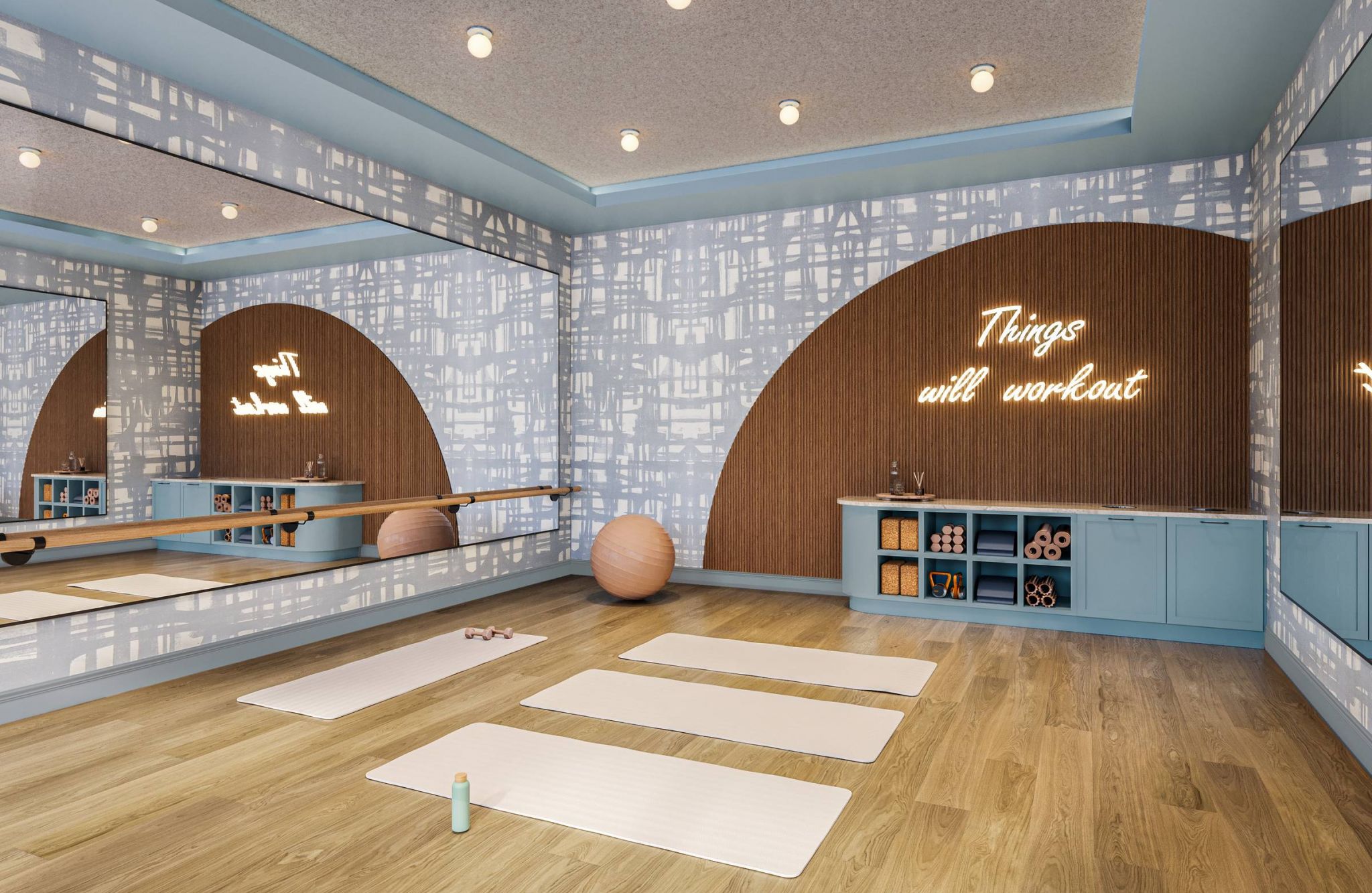 Ever College Station student living apartments Yoga studio with three mats, exercise balls, mirrors, and a neon sign that reads "Things will workout.
