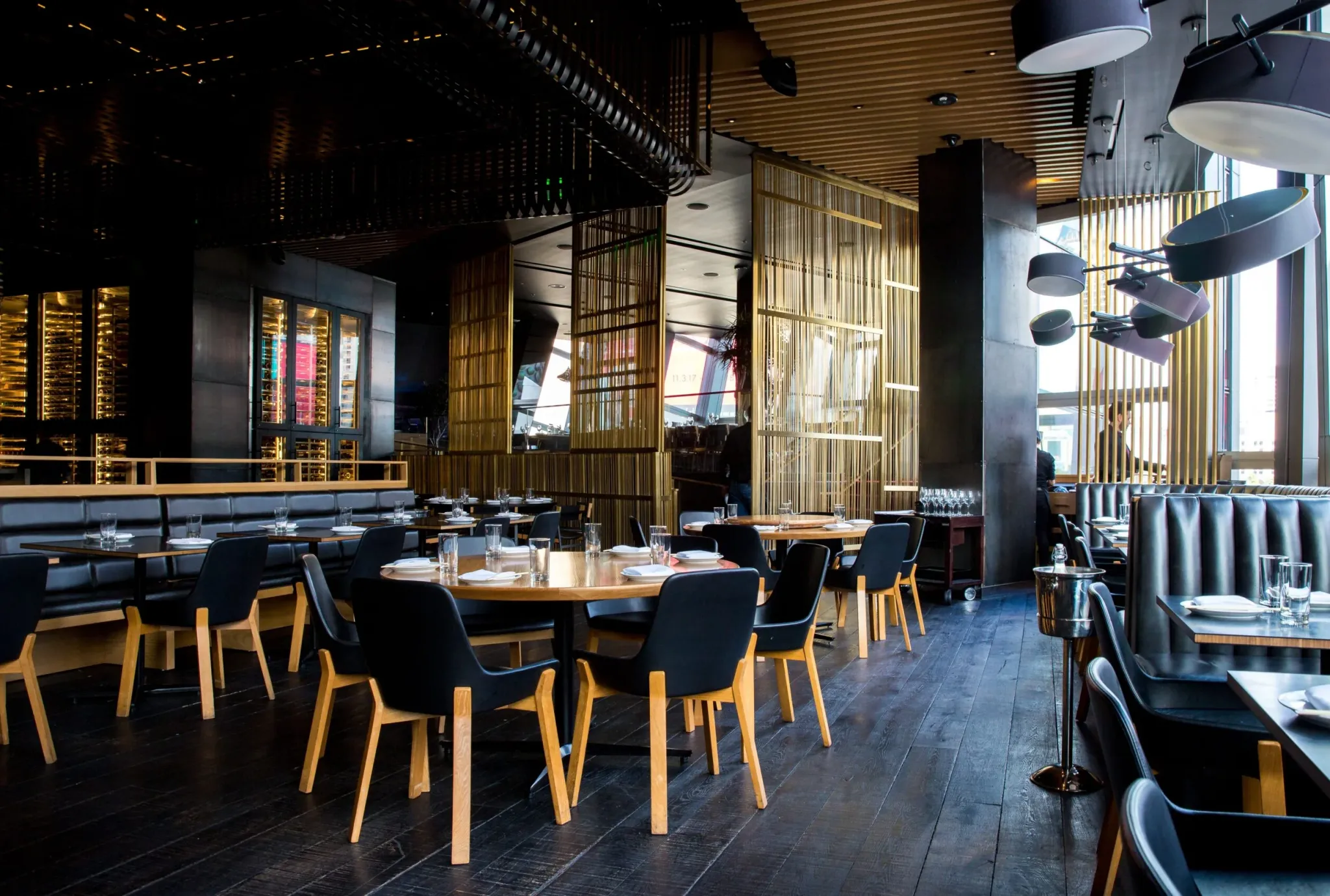 Modern restaurant featuring tables and chairs and low lighting