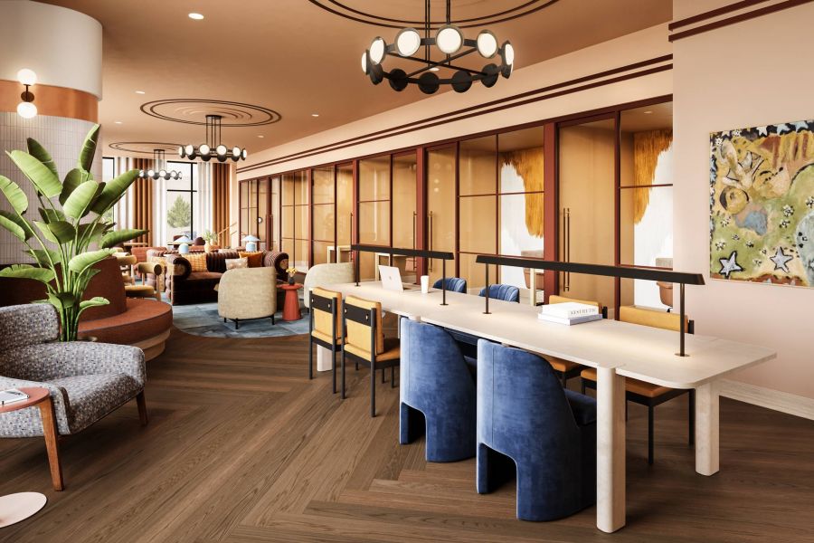 Ever College Station student living apartments Modern co-working space with stylish lounge chairs, long table, large windows, and abstract wall art.
